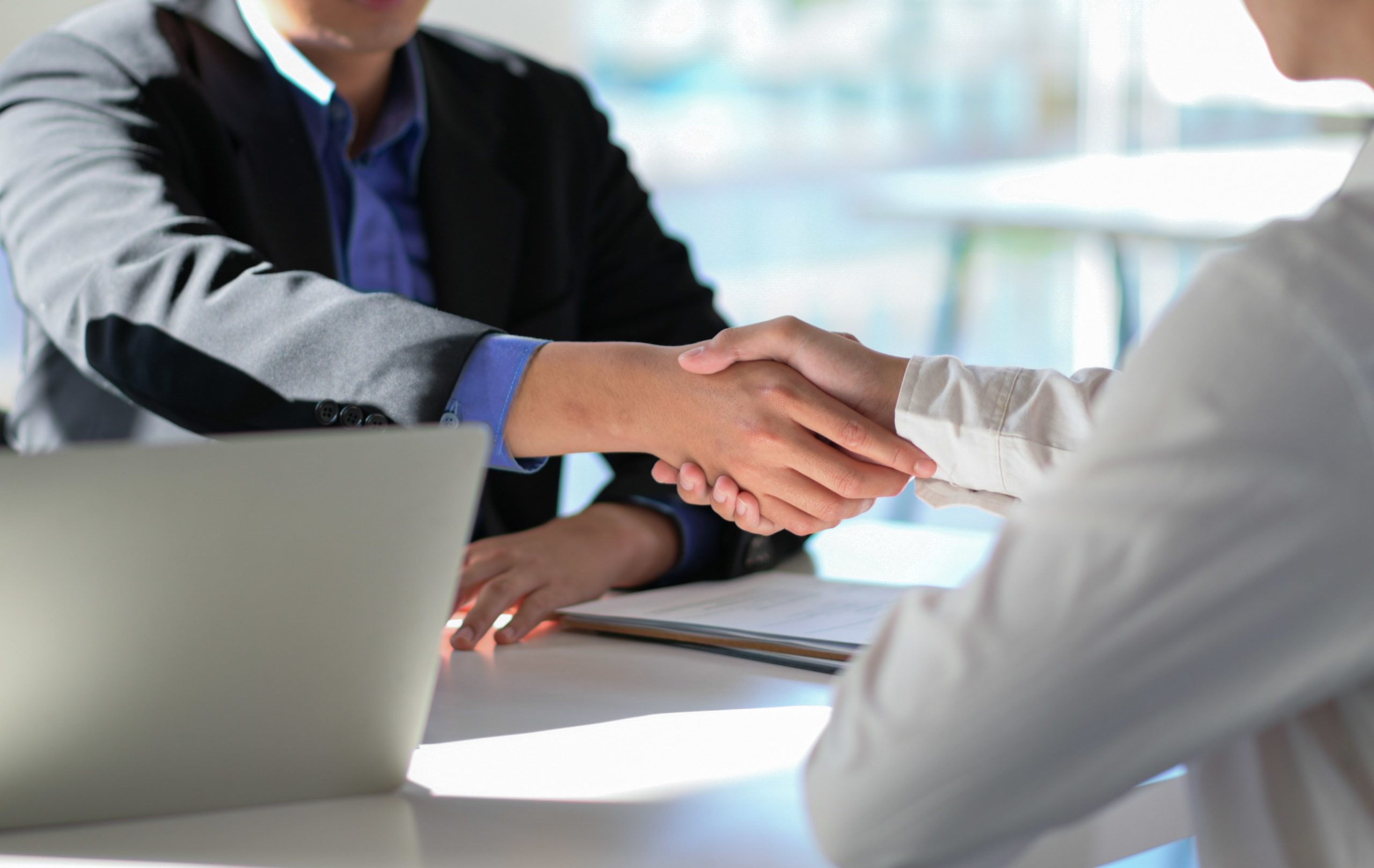 Cropped-shot-of-executives-join-hands-to-congratul-duqrp7e-min