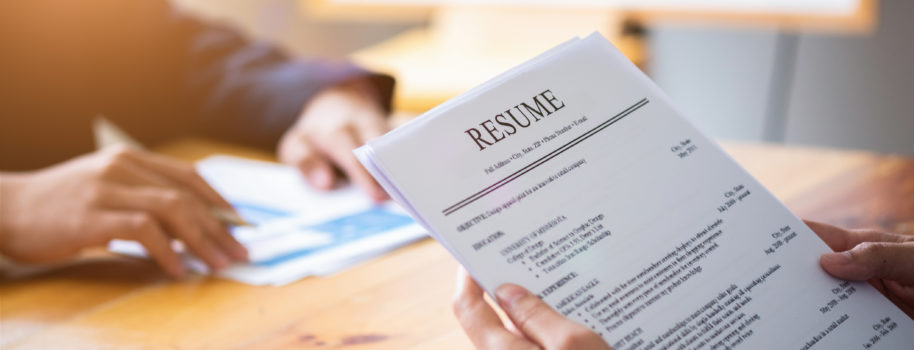 Interviewer Reading A Resume, Person Submits Job Application, Person Describe Yourself To Interviewer, Close Up View Of Job Interview In ...